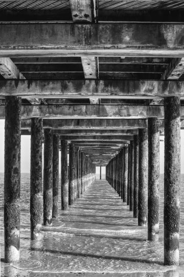 Pier-underside-rust-waves-shadows-convergence-monochrome-Southwold-Suffolk-2013-15032022